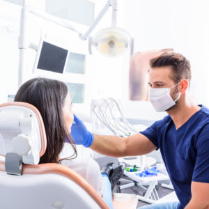 Orthodontist treating young patient